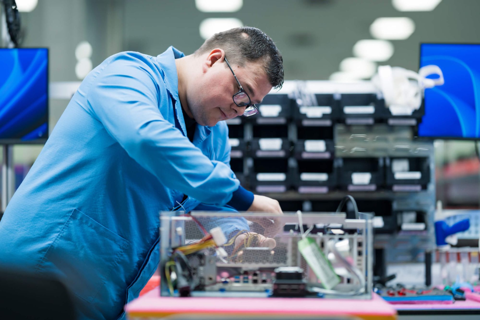 Axiom technician putting together switch board