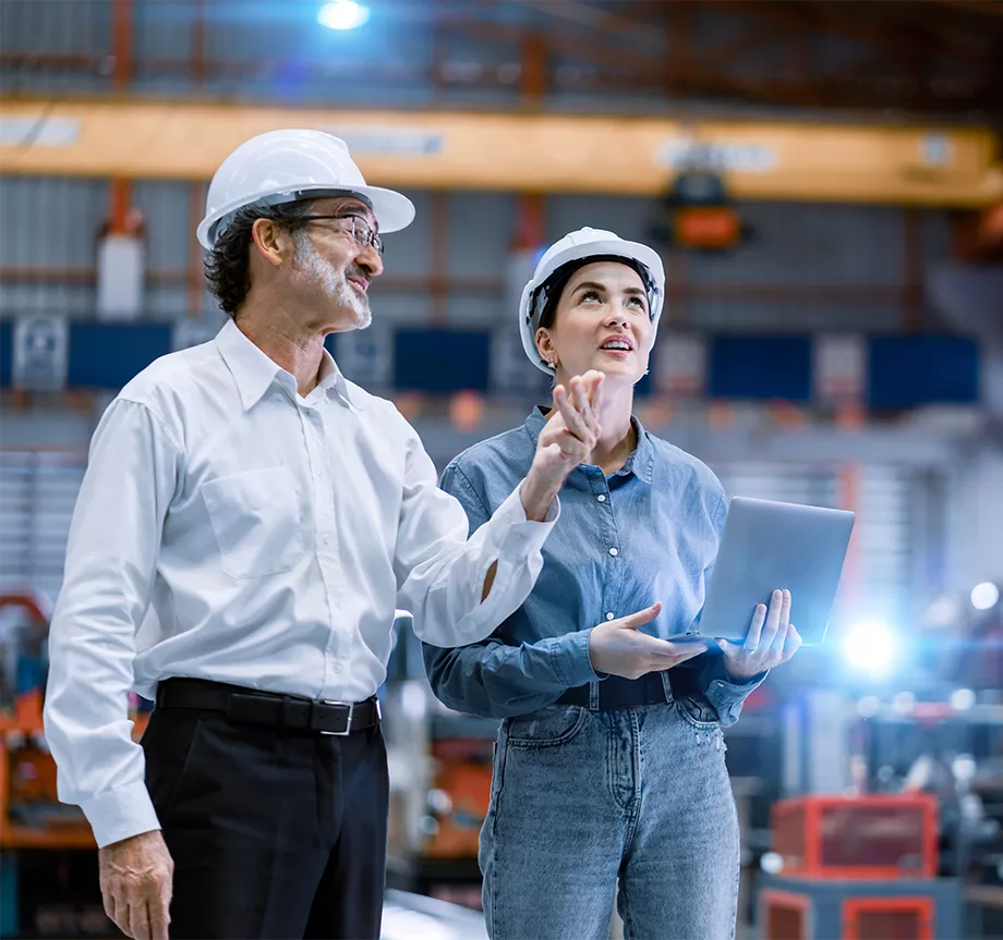 Professional engineer,worker,technician use clipboard discuss work, walk in steel metal manufacture factory plant industry