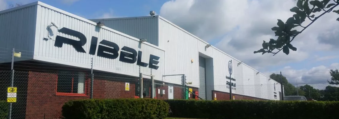 Exterior view of the Ribble Cycles headquarters building with the Ribble logo on the facade